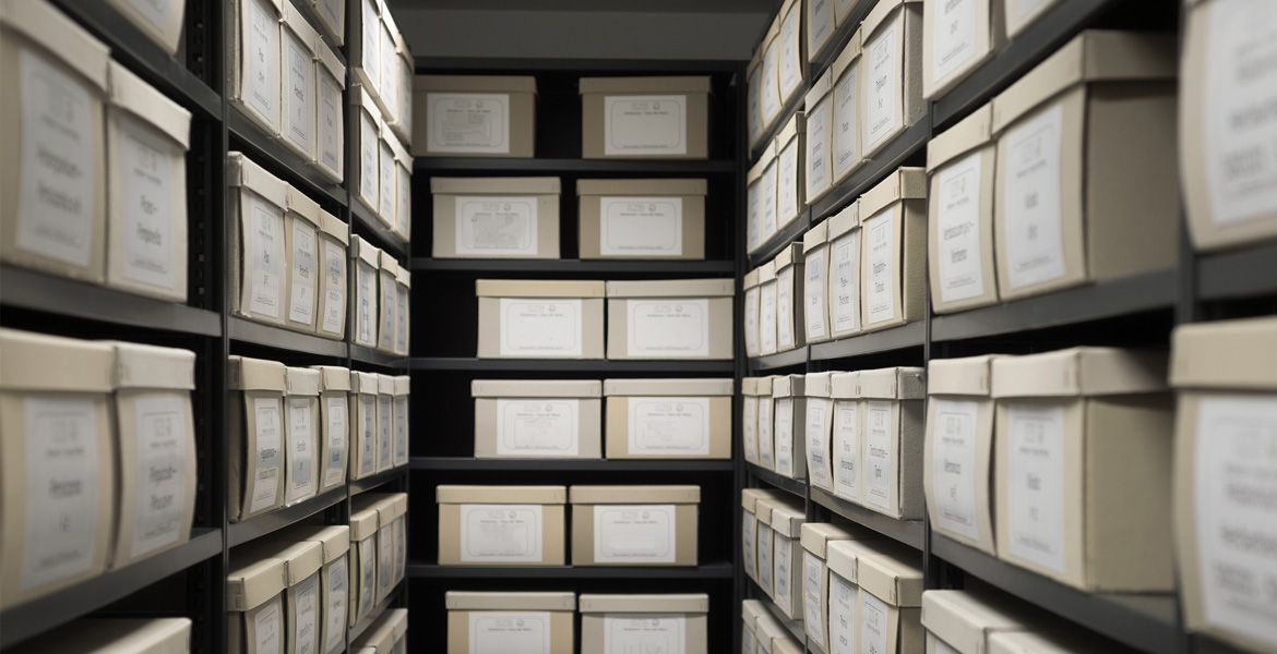 Archiv, Innenlager in einem Produktionsbetrieb, schwarze Regale mit weißen Büroboxen